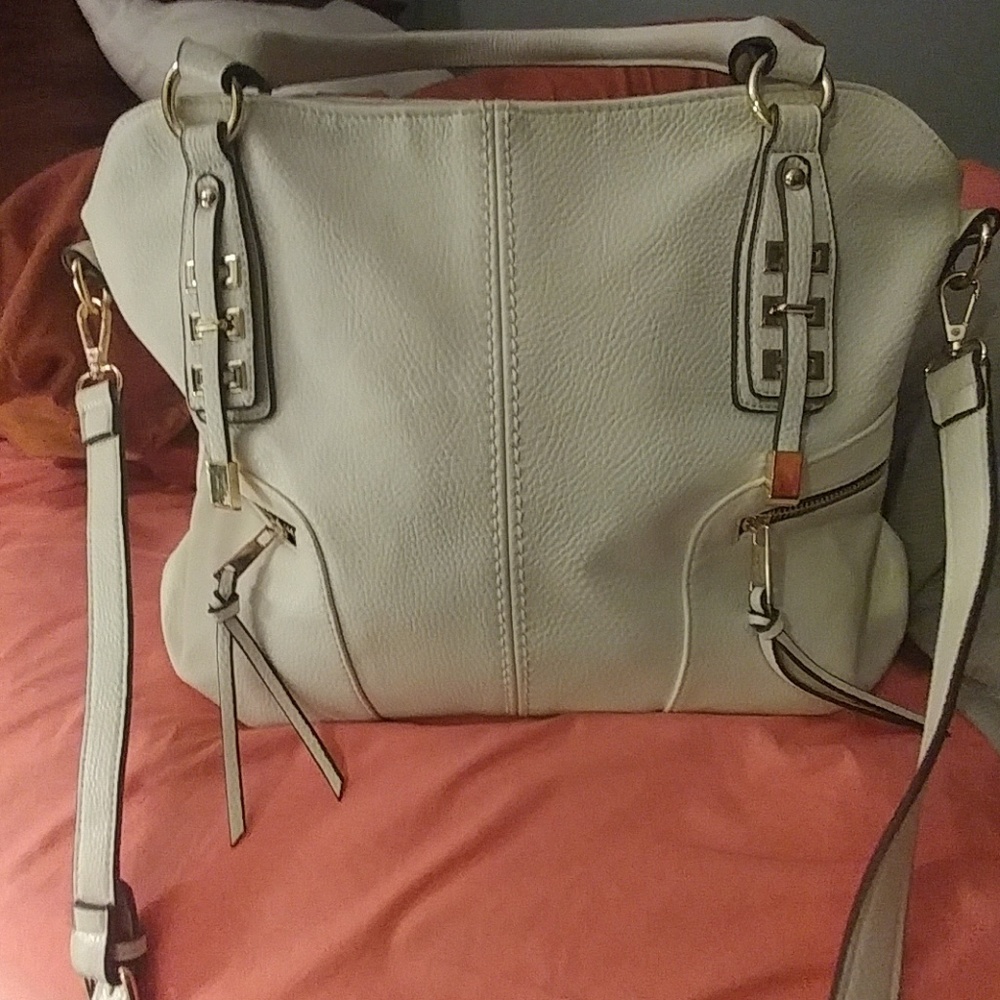 Great Gorgeous cream with Gold hardware handbag. Like new condition cloth lining